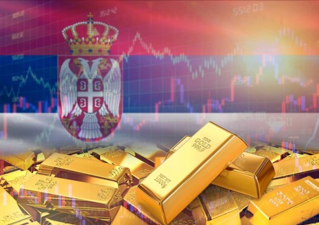 Gold bars on Serbia flag in background. Gold bars stacked on Serbian flag. Concept of Serbia gold