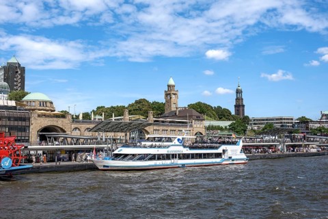 Elbe and boats at St. Pauli Landungsbrücken, historic building with water level tower, Hamburg,