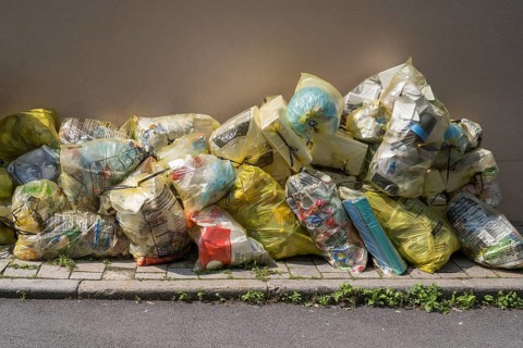 Yellow bags for plastic waste are lying on the side of the road, waste separation, waste disposal,