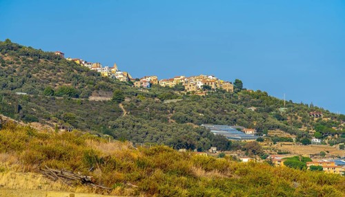 Small village on hill top seen in Liguria, Italy