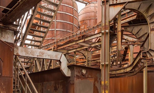 Weathered rusty industrial scenery with old corroded steel girders and metal tubes