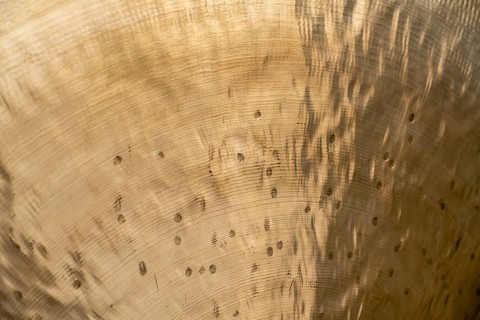 Full frame abstract closeup shot of a metallic asian gong