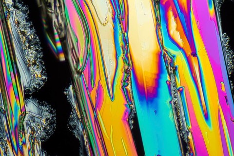 Colorful microscopic shot of Sodium nitrate microcrystals in polarized light