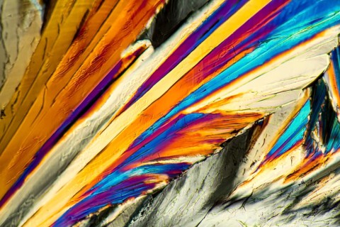 Colorful microscopic shot of Sucrose micro crystals in polarized light