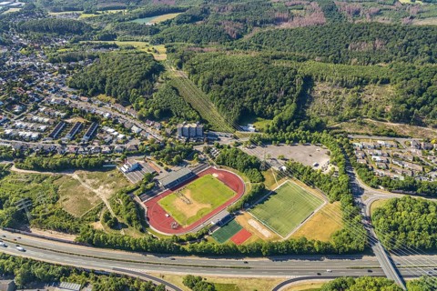Aerial view, stadium above ground high voltage road, high voltage pylons, planned HStädt. building