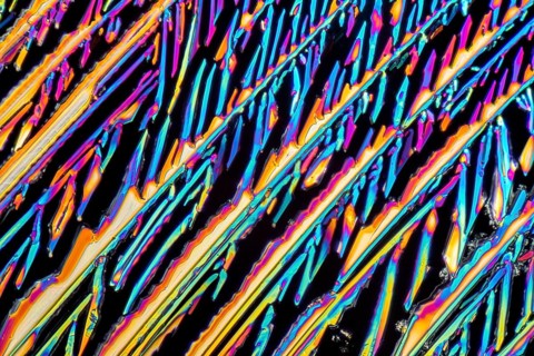 Colorful microscopic shot of Sodium nitrate microcrystals in polarized light