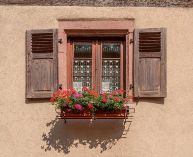 Sunny illuminated window seen in Kaysersberg, a historical town and former commune in Alsace in