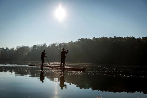 DEU Germany Germany Berlin Standup paddler (SUP) on the Krumme Lanke