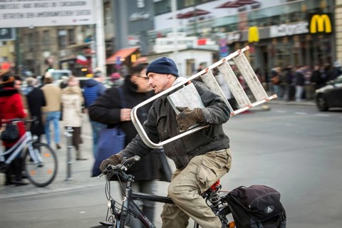 DEU Germany Germany Berlin Cyclist with trained ladder passes Checkpoint Charlie