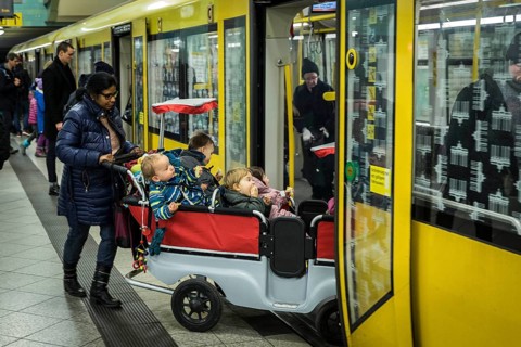 DEU Germany Germany Berlin Carer with pram for several kindergarten children in the underground