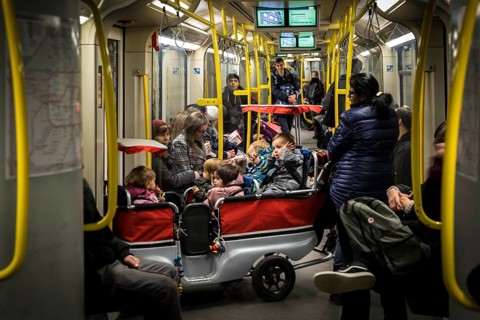 DEU Germany Germany Berlin Carer with pram for several kindergarten children in the underground