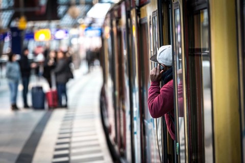 DEU Germany Germany Berlin A traveller makes a phone call from an S-Bahn train at the main station