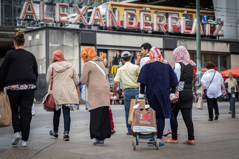 DEU Germany Germany Berlin Muslim family with a hackney carriage on Alexanderplatz. 'I love