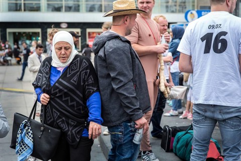 DEU Germany Germany Berlin A Muslim woman passes a young man on Alexanderplatz