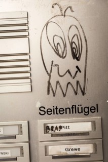 DEU Germany Germany Berlin A face on a doorbell sign in Neukölln