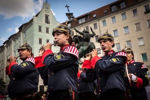 DEU Germany Germany Berlin A marching band with traditional uniforms marches through the Nikolai