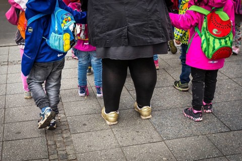 DEU Germany Germany Berlin A kindergarten teacher waits with children at a traffic light