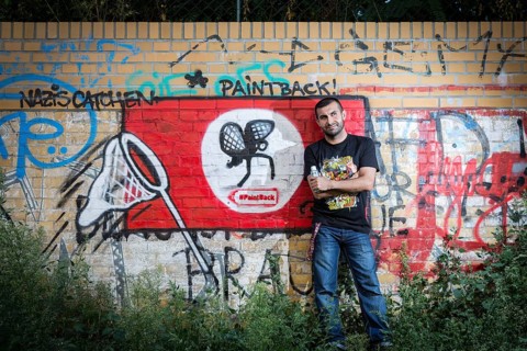Germany Germany DEU Berlin Graffiti artist Ibo Omari in front of one of his works on a playground