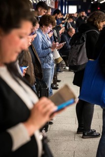 DEU Germany Germany Berlin Passengers look at their mobile phones while waiting for the train at