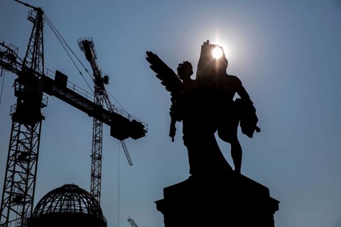 DEU Germany Germany Berlin The shell of the city palace backlit with statues on the bridge
