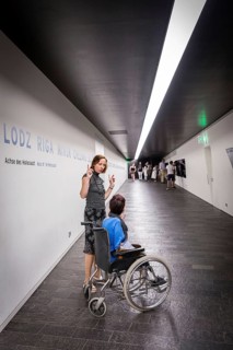 DEU Germany Germany Berlin Disabled tourist in a wheelchair explores Berlin with a city guide.