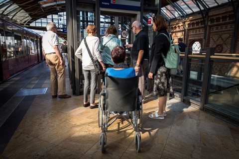 DEU Germany Germany Berlin Disabled tourist in a wheelchair explores Berlin with a city guide.