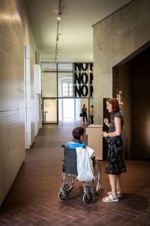 DEU Germany Germany Berlin Disabled tourist in a wheelchair explores Berlin with a city guide.