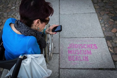 DEU Germany Germany Berlin Disabled tourist in a wheelchair explores Berlin with a city guide.