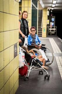 DEU Germany Germany Berlin Disabled tourist in a wheelchair explores Berlin with a city guide