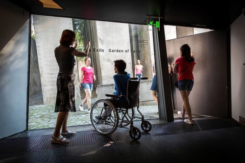 DEU Germany Germany Berlin Disabled tourist in a wheelchair explores Berlin with a city guide.