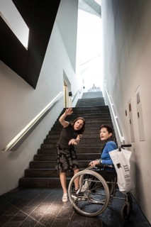 DEU Germany Germany Berlin Disabled tourist in a wheelchair explores Berlin with a city guide.