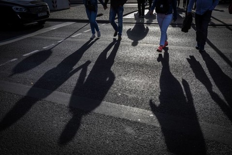 DEU Germany Germany Berlin Pedestrians cast their shadows on the street at Potsdamer Platz