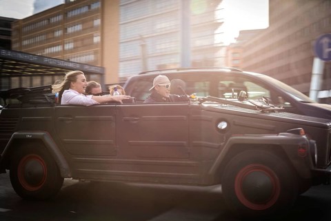 DEU Germany Germany Berlin Young people celebrating in a VW Kübelwagen on Potsdamer Platz