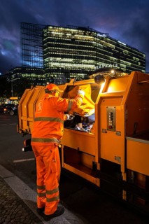 DEU Germany Germany Berlin A BSR employee unloads a rubbish bag in his vehicle on the Kudamm