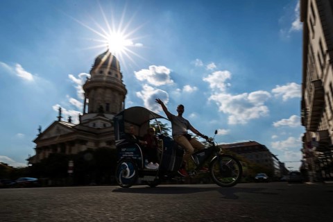 DEU Germany Germany Berlin A rickshaw driver shows his passengers the city