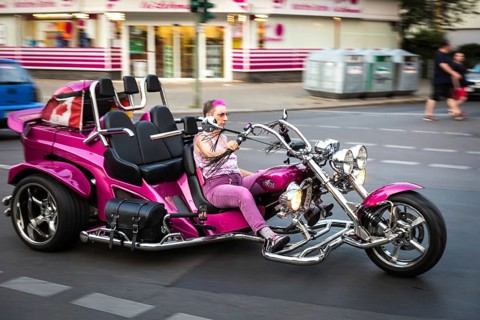 DEU Germany Germany Berlin A woman rides a fun bike through Uhlandstraße
