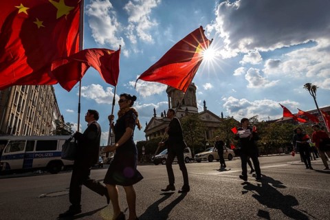 DEU Germany Germany Berlin A group with Chinese flags walks across the Gendarmenmarkt to