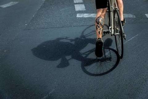 DEU Germany Germany Berlin A huge tattoo adorns the calf of a cyclist just starting out on