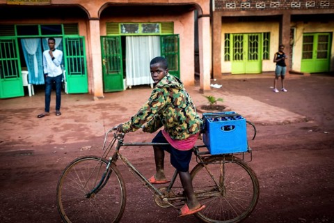 RWA RWANDA Rwanda Rukara A cyclist wearing a camouflage jacket transports drinks
