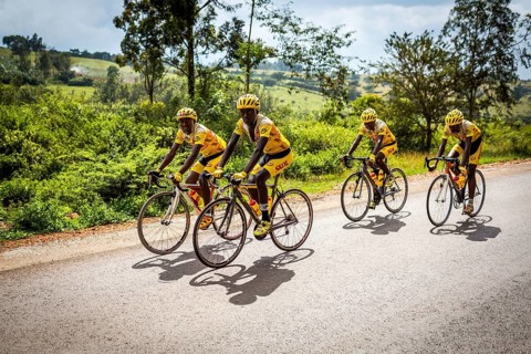 RWA RWANDA Rwanda Gahini cyclists train on a road at Lake Muhazi