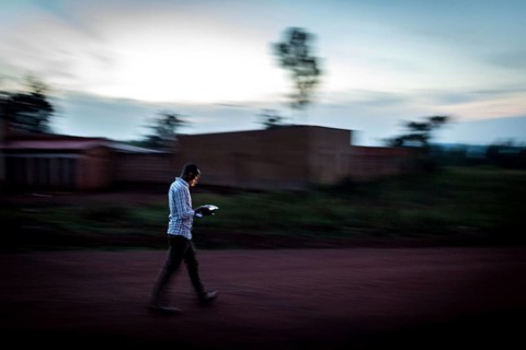 RWA RWANDA Rwanda Rukara A student looks at his smartphone while walking