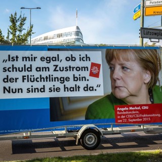 DEU Germany Germany Berlin Supporters with AFD poster against Merkel's refugee policy in front of