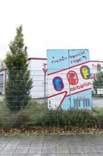 DEU Germany Germany Berlin A closed Air Berlin hangar with graffiti by Thierry Noir on pieces of