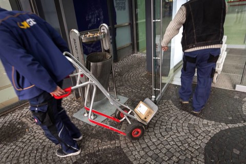 DEU Germany Germany Berlin A courier with grocery orders enters the Europe Centre while a parcel