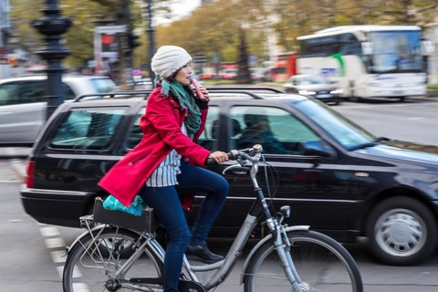 DEU Germany Germany Berlin A cyclist rides with a suitcase on the pavement