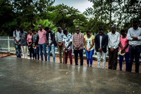 RWA RWANDA RUANDA Kigali A youth group stands in front of a mass grave at the genocide memorial