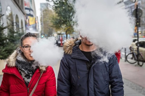 DEU Germany Germany Berlin A couple with an e-cigarette blowing out vapour