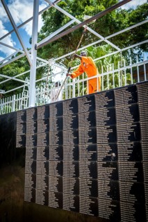 RWA RWANDA RUANDA Kigali Working at the memorial in front of a list of names in preparation for the