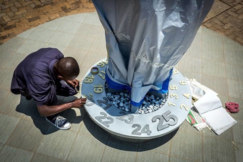 RWA RWANDA RUANDA Kigali An assistant completing the flame in preparation for the genocide