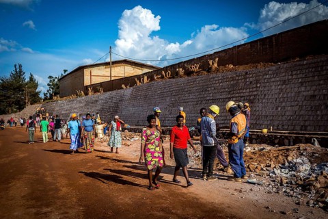 RWA RWANDA RUANDA Kigali Pedestrians walk through a road construction site in Gikondo district